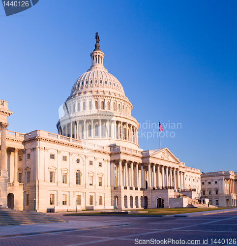 Image of Rising sun illuminates the front of the Capitol building in DC