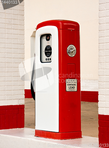 Image of White and red ancient gas pump