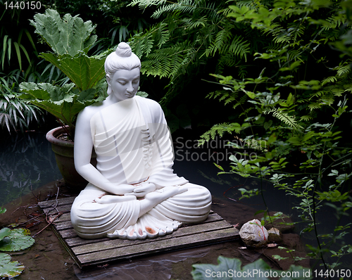 Image of Buddha statue in pond