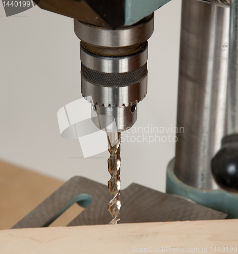 Image of Close up of drill bit above wood