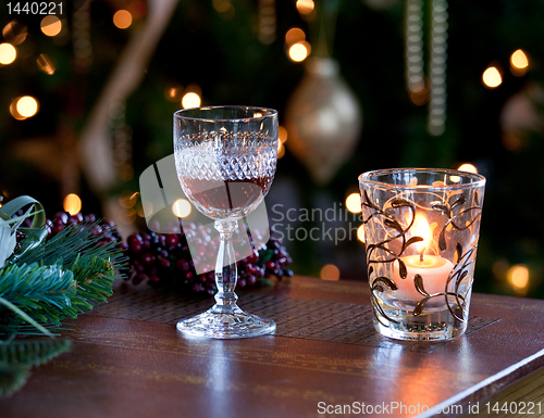 Image of Glass of sherry or port by candlelight