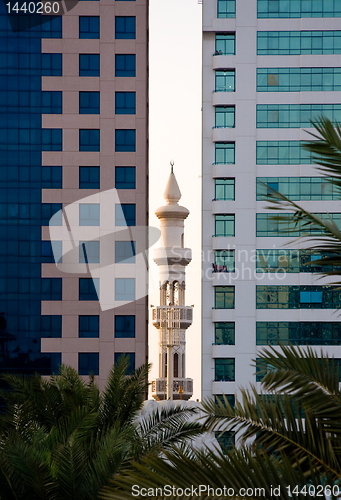 Image of Minaret peeping between office buildings