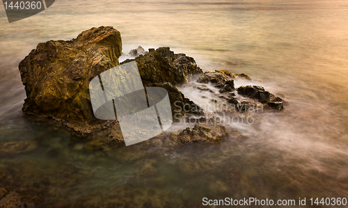 Image of Long exposure sunset on sea rocks