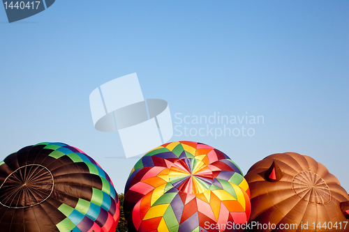 Image of Three Hot air balloons being inflated