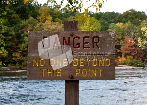 Image of Danger sign by river