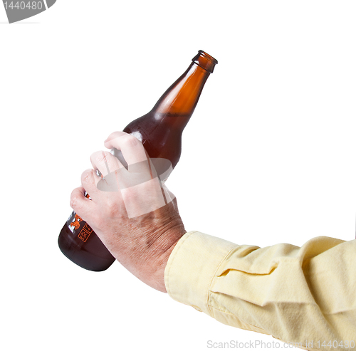 Image of Brown bottle of beer in old hand