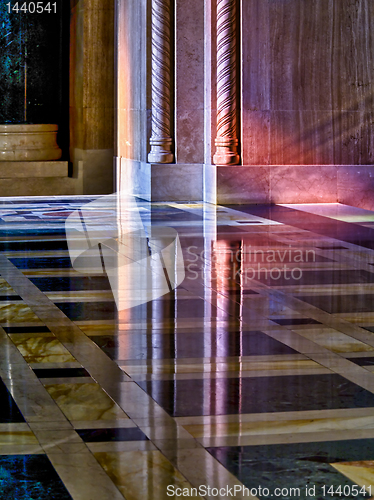 Image of Light from stained glass windows on wall of church