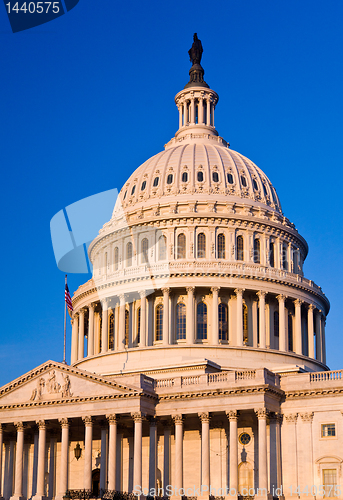 Image of Rising sun illuminates the front of the Capitol building in DC