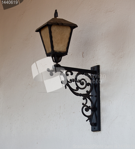 Image of Ornate glass lantern against wall