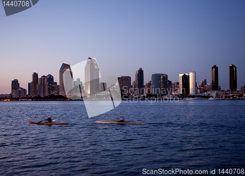 Image of San Diego skyline on clear evening with kayaks