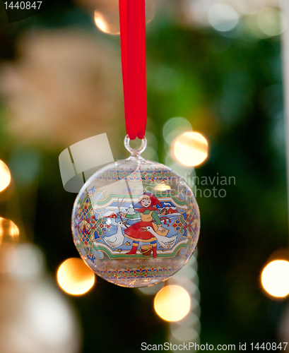 Image of Glass ornament in front of Christmas tree