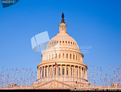 Image of Rising sun illuminates the front of the Capitol building in DC