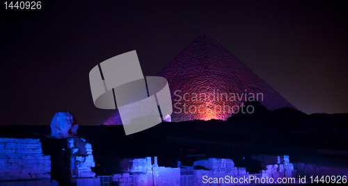Image of Colored lights illuminate Sphinx and Pyramids