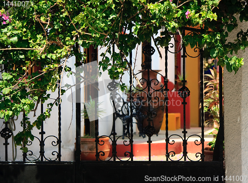 Image of Ornate iron gates with patio