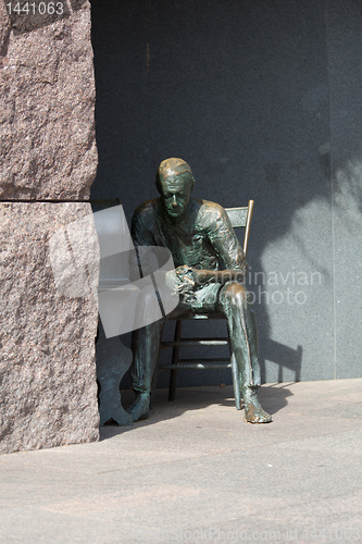 Image of Statue of poor man listening to radio