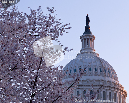 Image of Sunrise behind the dome of the Capitol in DC