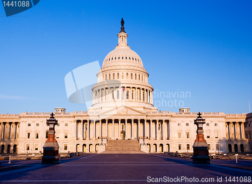 Image of Rising sun illuminates the front of the Capitol building in DC