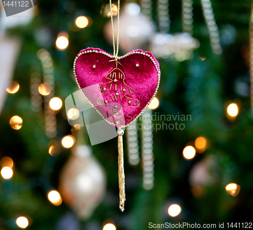 Image of Red velvet heart in front of xmas tree