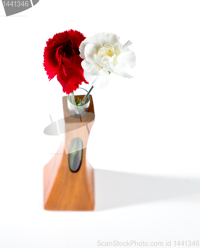 Image of Red and white spray carnations in teak vase