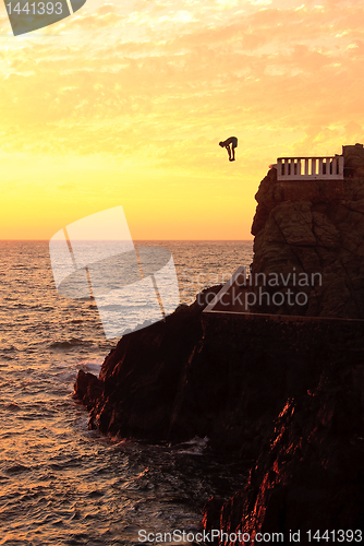 Image of Cliff diver off the coast of Mazatlan at sunset