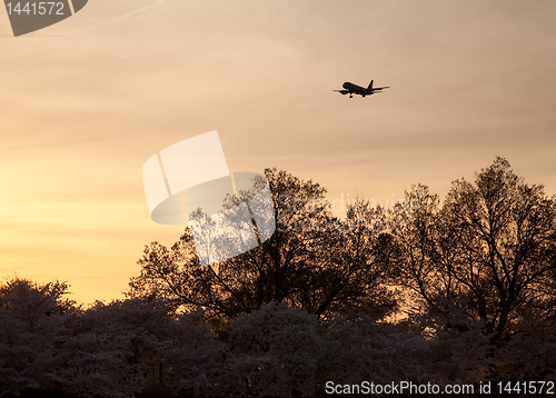 Image of Aircraft landing at Reagan National airport at sunset