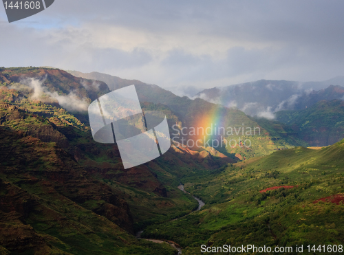 Image of Rainbow falling on river in Waimea Canyon