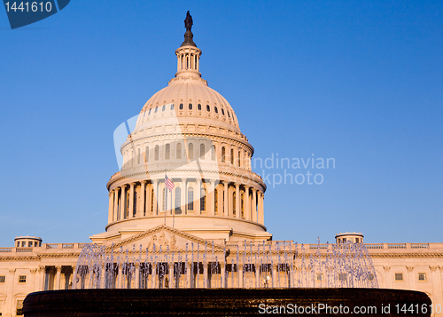 Image of Rising sun illuminates the front of the Capitol building in DC