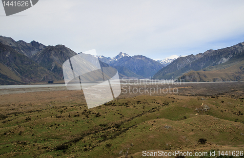 Image of Mount Cook over a grassy plain