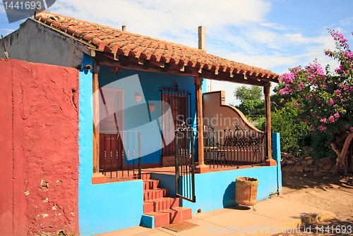 Image of Blue house with bright red wall