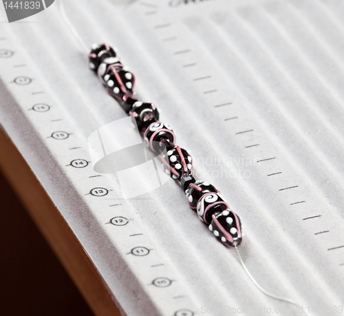 Image of Line of black and pink beads