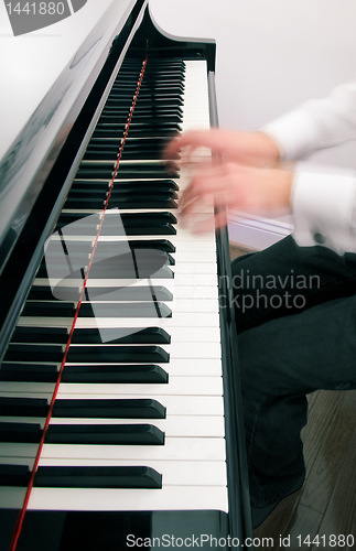 Image of Pianist hands playing the grand piano