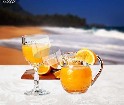 Image of Glass of orange on the beach