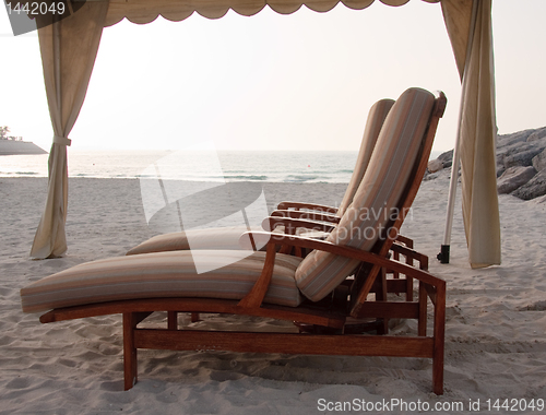 Image of Pair of sun loungers on beach