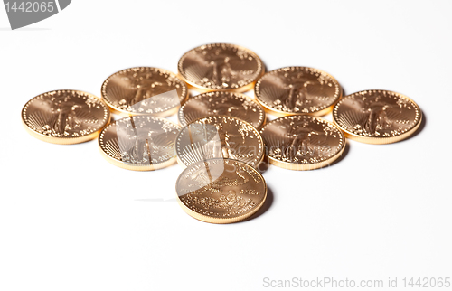 Image of Diamond shaped gold coins on white