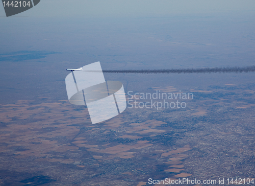 Image of Airliner with long smoke plume