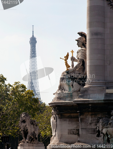 Image of Eiffel tower framed by statue on Pont Alexandre Bridge