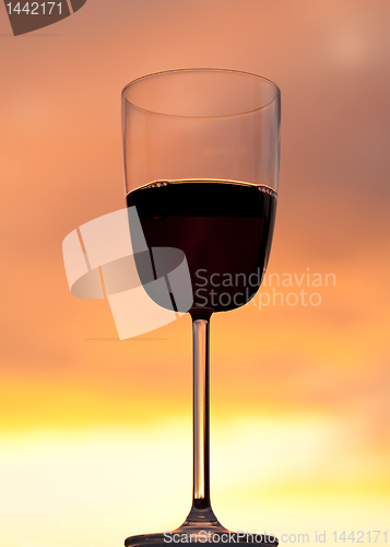 Image of Sunset behind glass of red wine