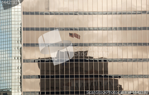 Image of US Flag reflected in office buildings