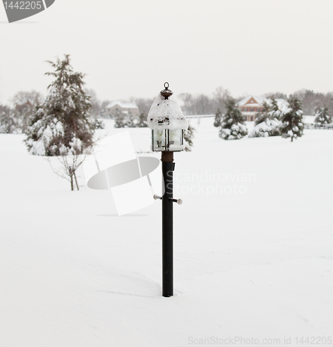 Image of Lamp post deep in snow