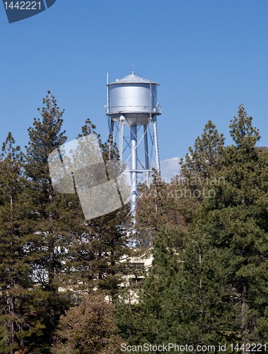 Image of Water tower peeps above tree line