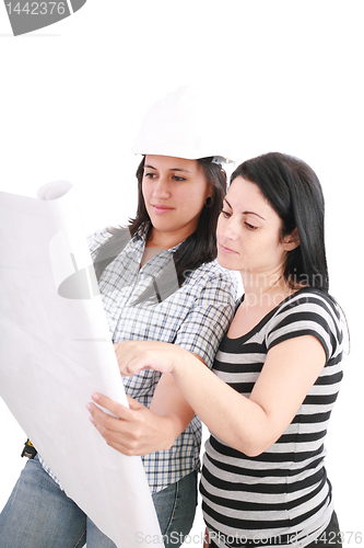 Image of Attractive young engineer with helmet studying planes with her c