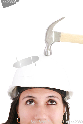 Image of girl with safety helmet about to be hit by a hammer over a white