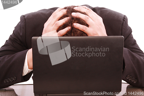 Image of a successful business man is frustrated on a table with a laptop