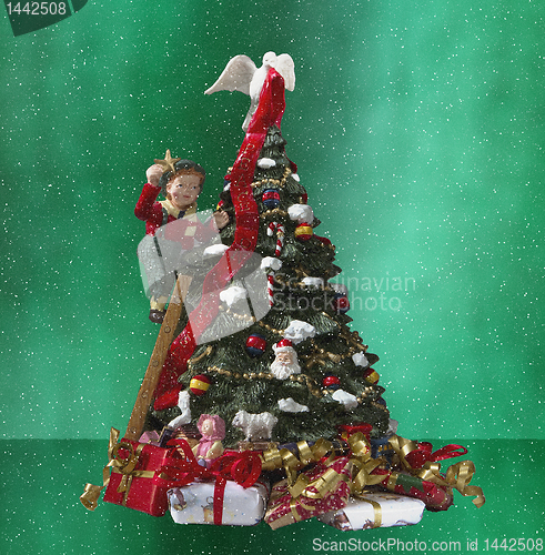 Image of A small boy decorating a christamas tree