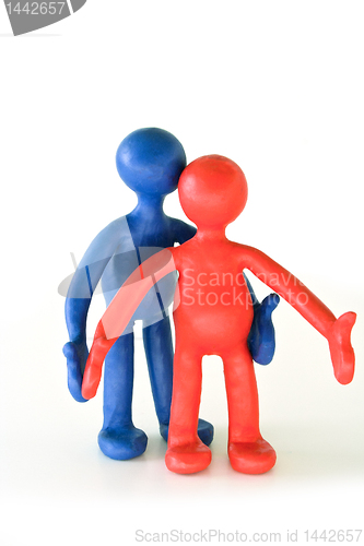 Image of colored plasticine puppets standing on white background