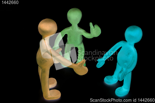 Image of Shaded plasticine puppets talking on black background