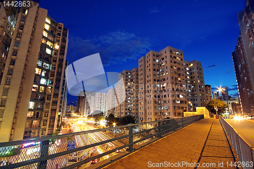 Image of modern urban city at night with freeway traffic