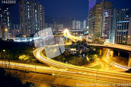 Image of urban area dusk, busy traffic 