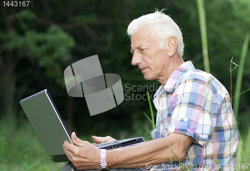 Image of An elderly man with a laptop