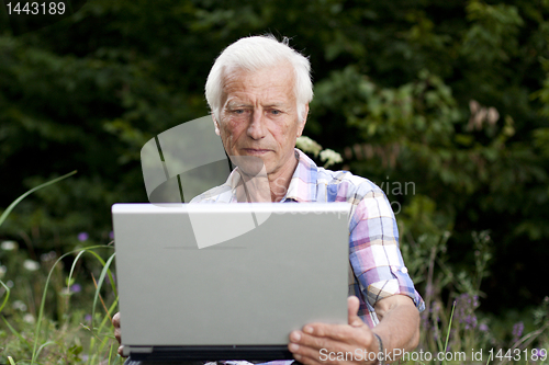 Image of An elderly man with a laptop